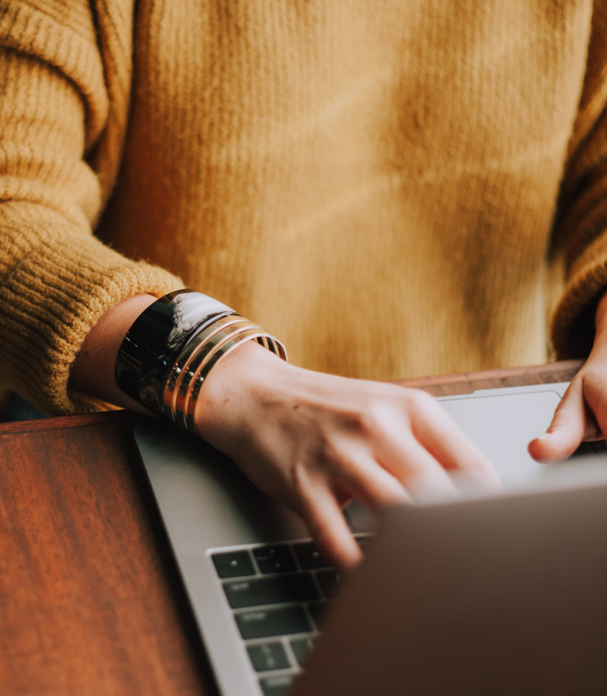 Woman Typing on a Laptop